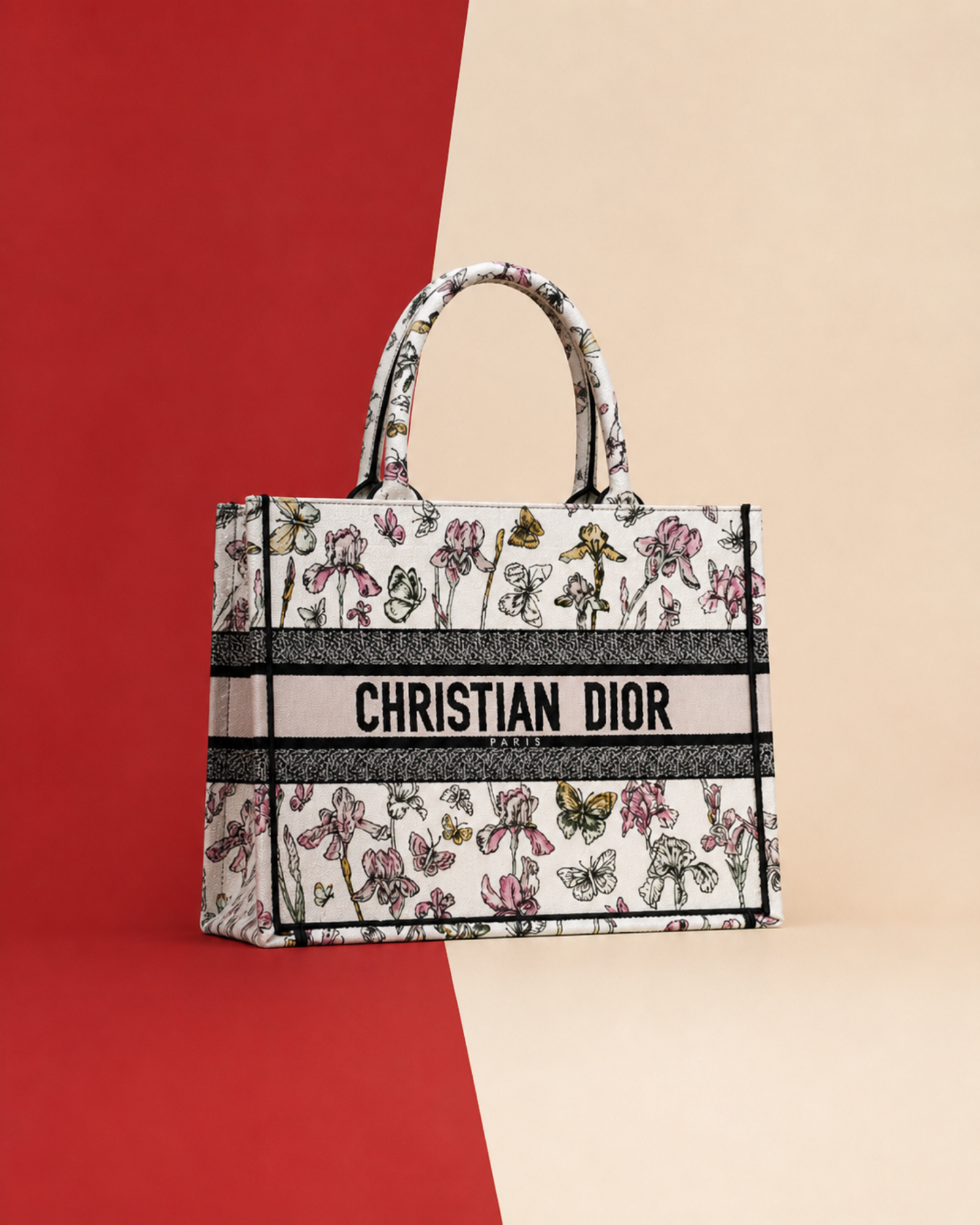 Christian Dior Book Tote with floral embroidery on a red and cream backdrop